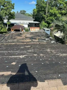 Old roof stripped down to decking during full roofing replacement project by NF Home Improvements in Opa-locka FL
